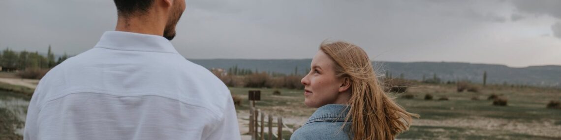 couple in jean jacket and white shirt
