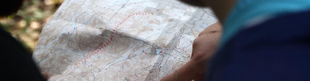 person pointing on beige map
